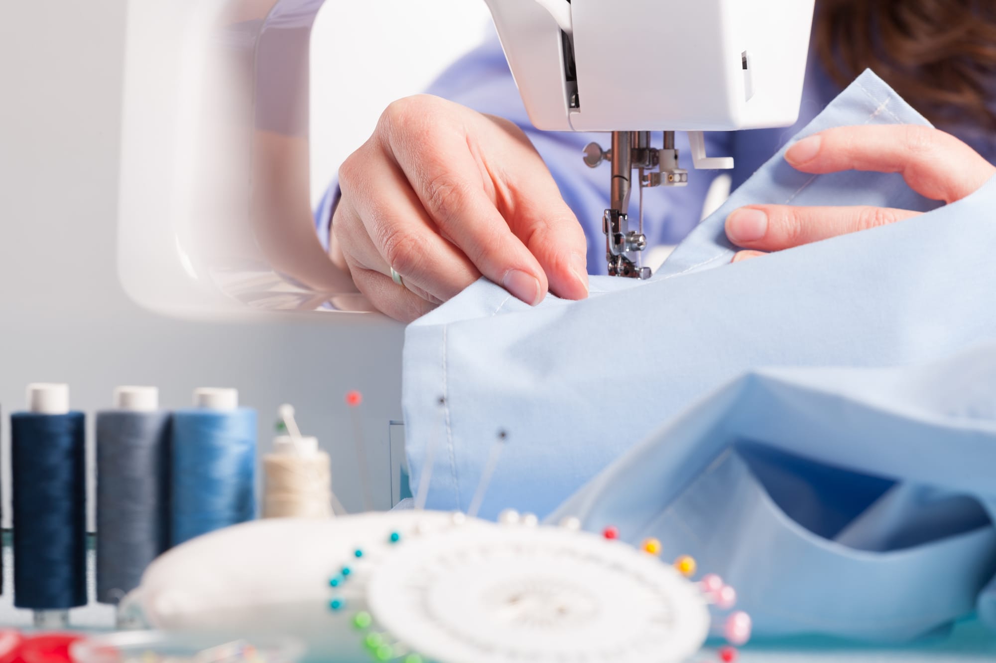 woman sewing on a machine seen from close up