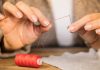 How to Pick the Best Yarn Needle – The Ultimate Guide man putting a thread through a needle