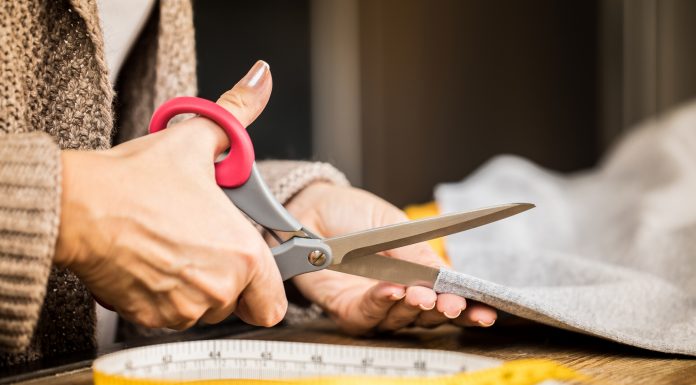 woman cutting fabric with scissors