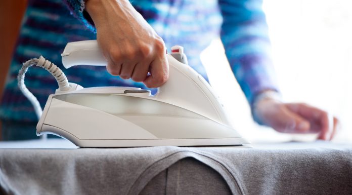 lady ironing clothes with her iron